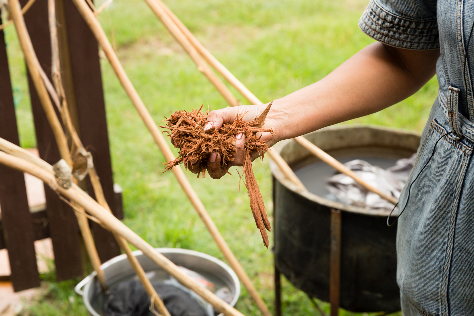 Delvene holding bark used in creating the artwork