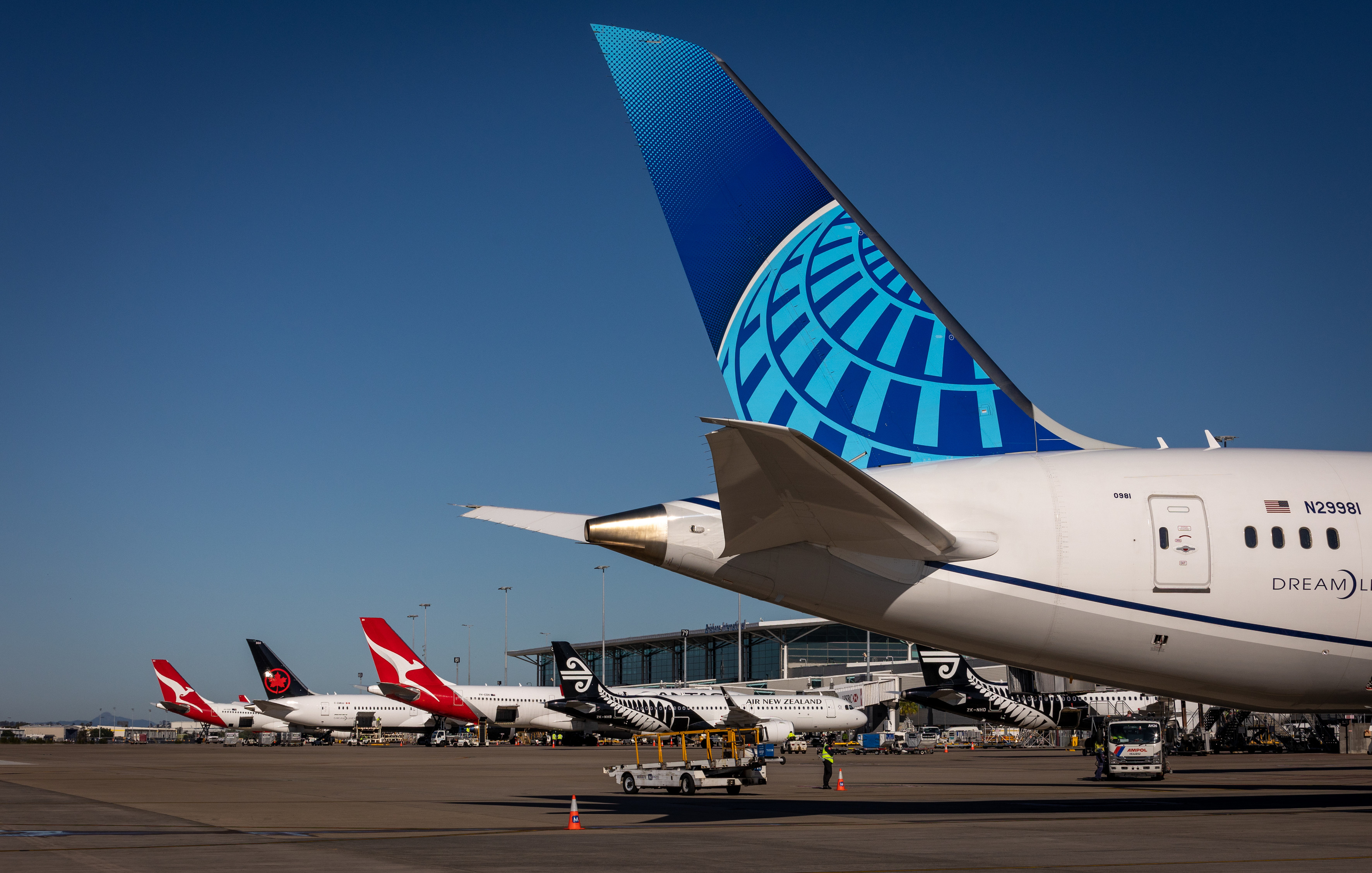 United Airlines plane tail in the front with three planes in the background