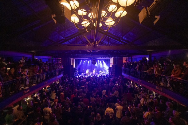 A band playing onstage at The Tivoli to a packed crowd 