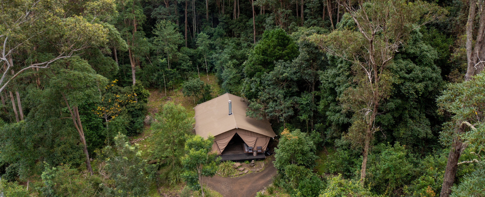 Nightfall glamping tent among the trees