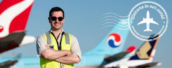 BAC Employee in front of plane tails